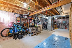Unfinished basement featuring exposed wood joists and concrete flooring - 