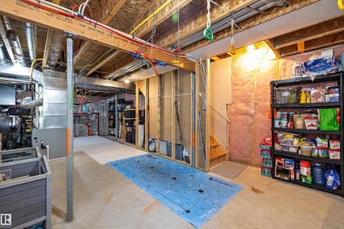 Unfinished basement area with exposed joists, visible HVAC ductwork, and plumbing - 12305 173A Avenue Nw, Edmonton, AB - Indoor Photo Showing Basement