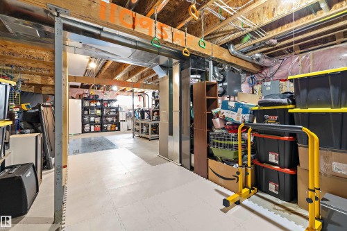 Unfinished basement featuring exposed wood joists and structural beams, along with visible HVAC ductwork and electrical conduit - 12305 173A Avenue Nw, Edmonton, AB - Indoor Photo Showing Basement
