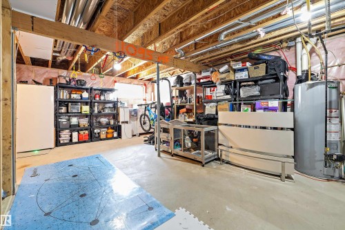 Unfinished basement featuring exposed wood joists and structural beams, concrete flooring, and visible utility infrastructure including plumbing and electrical conduits - 12305 173A Avenue Nw, Edmonton, AB - Indoor Photo Showing Basement