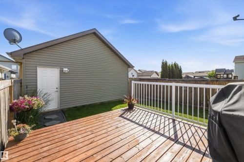 Expansive wood-finish deck with white railing - 12305 173A Avenue Nw, Edmonton, AB - Outdoor With Deck Patio Veranda With Exterior
