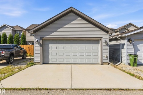 Detached garage with light gray siding and a paneled overhead door - 12305 173A Avenue Nw, Edmonton, AB - Outdoor