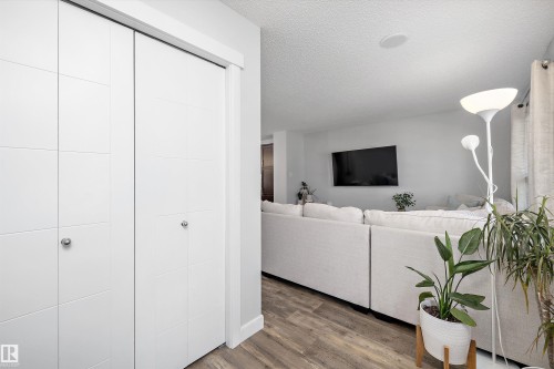White bi-fold doors with circular chrome hardware - 12305 173A Avenue Nw, Edmonton, AB - Indoor Photo Showing Other Room