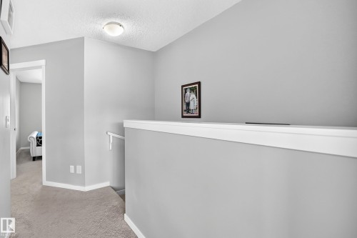 Upper-level hallway featuring light gray painted walls and white baseboards - 5280 21 Avenue Sw, Edmonton, AB - Indoor Photo Showing Other Room
