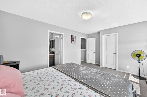 Carpeted bedroom with light gray walls and a semi-flush mount ceiling light - 5280 21 Avenue Sw, Edmonton, AB - Indoor Photo Showing Bedroom