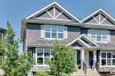 Contemporary townhome exterior featuring multi-toned siding and stone accents - 5280 21 Avenue Sw, Edmonton, AB  - Outdoor With Facade 