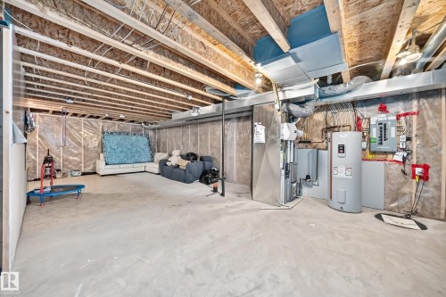 Unfinished basement with exposed wood joists and concrete flooring - 5280 21 Avenue Sw, Edmonton, AB - Indoor Photo Showing Basement