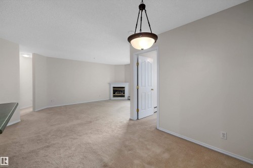 #207 911 Rabbit Hill Rd Nw, Edmonton, AB - Indoor Photo Showing Other Room With Fireplace