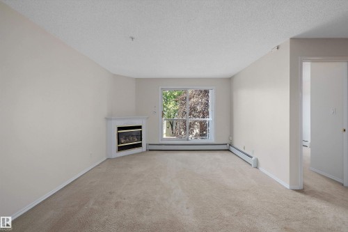 #207 911 Rabbit Hill Rd Nw, Edmonton, AB - Indoor With Fireplace