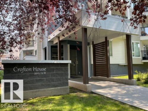 Building entrance featuring a contemporary design with a prominent "Crofton House" stone monument - #206, 9905 112 St Nw, Edmonton, AB - Outdoor