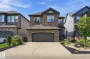 Two-story residence featuring a stone and siding exterior with a prominent front-facing two-car garage - 3 Garneau Gate, Spruce Grove, AB  - Outdoor With Facade 