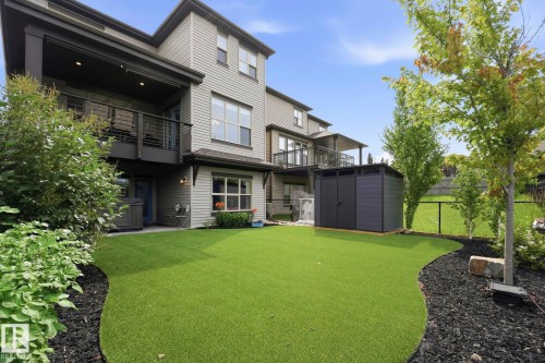 Backyard featuring artificial turf, a dark gray storage shed, and a privacy fence - 3 Garneau Gate, Spruce Grove, AB - Outdoor