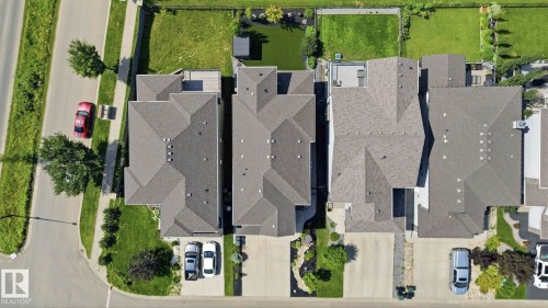 Aerial perspective showcasing properties with shingled roofs and private driveways - 3 Garneau Gate, Spruce Grove, AB - 
