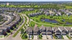 Aerial perspective of a developed residential area featuring a curvilinear street layout - 