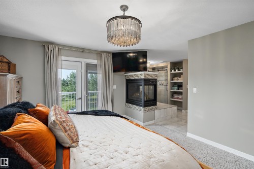 180 Sheppard Circle, Leduc, AB - Indoor Photo Showing Bedroom With Fireplace