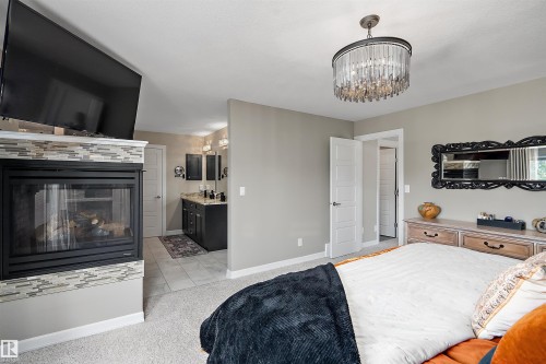 180 Sheppard Circle, Leduc, AB - Indoor Photo Showing Bedroom With Fireplace
