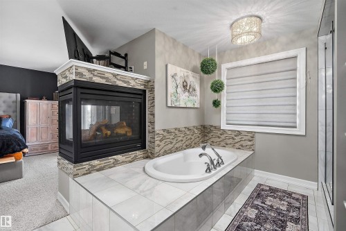 180 Sheppard Circle, Leduc, AB - Indoor Photo Showing Bathroom With Fireplace