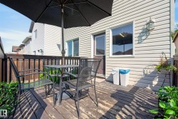 Outdoor wood deck featuring a privacy fence, exterior siding, and an exterior door - 