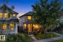 Siding exterior with a covered front porch, dark railing, and a concrete pathway - 3003 20 Avenue Nw, Edmonton, AB  - Outdoor With Deck Patio Veranda 