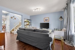 Living area featuring dark wood-finish flooring and light blue wall paint - 