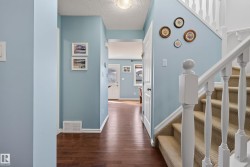 Entryway featuring wood-finish flooring extending into the interior - 