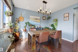 Dining area featuring wood-finish flooring and light blue walls - 