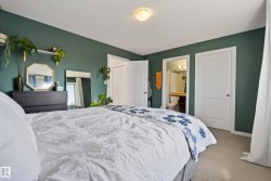 Interior space featuring a private bathroom with a vanity and toilet, two paneled doors, and a ceiling-mounted light fixture - 