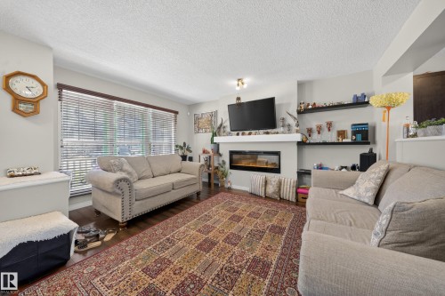 4680 Crabapple Run Run Sw, Edmonton, AB - Indoor Photo Showing Living Room With Fireplace