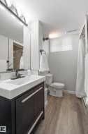 Modern vanity with integrated sink, matte black faucet, and sleek hardware - 