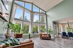 Two-story window wall with abundant natural light and exterior balcony access - 