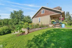 Two-story residence featuring a covered front porch with steps, a shingle-sided upper level, and a light-colored siding on the lower level - 