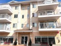 Multi-story residential building featuring textured stucco exterior, multiple private balconies with white railings, and an inviting main entrance with transom windows and a building name sign - #147 13441 127 St Nw, Edmonton, AB 