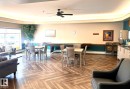 Open concept common area featuring wood-finish flooring with a herringbone pattern - #147 13441 127 St Nw, Edmonton, AB 