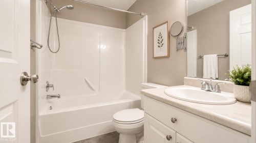 Full bathroom featuring a single vanity with an integrated sink, white cabinetry, and a full mirror - 29 Campbell Road, Leduc, AB - Indoor Photo Showing Bathroom