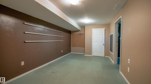 Open room featuring wall-to-wall carpeting and neutral wall tones - 29 Campbell Road, Leduc, AB - Indoor Photo Showing Other Room