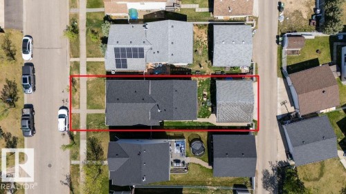 Aerial view of a residential property with a dark shingle roof and a detached garage featuring a light gray shingle roof - 29 Campbell Road, Leduc, AB - Outdoor With View