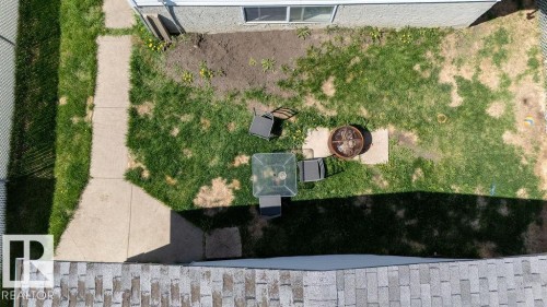 Private outdoor space featuring a concrete pathway, a fenced perimeter, and a fire pit area - 29 Campbell Road, Leduc, AB - Outdoor