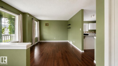 Spacious room with dark wood-finish flooring - 29 Campbell Road, Leduc, AB - Indoor Photo Showing Other Room
