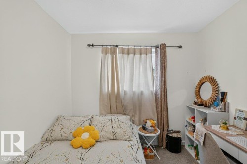 Neutral wall paint and textured carpeting - 12219 89 Street Nw, Edmonton, AB - Indoor Photo Showing Bedroom