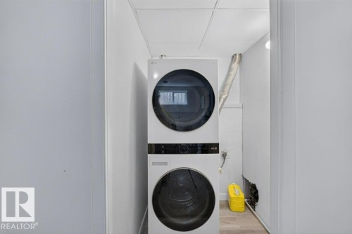 Dedicated laundry area featuring a stacked washer and dryer unit - 12219 89 Street Nw, Edmonton, AB - Indoor Photo Showing Laundry Room