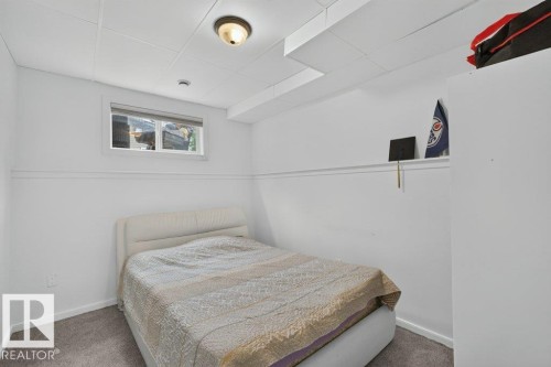 Room featuring white walls with a chair rail, a drop ceiling with recessed lighting, and grey carpet flooring - 12219 89 Street Nw, Edmonton, AB - Indoor Photo Showing Bedroom