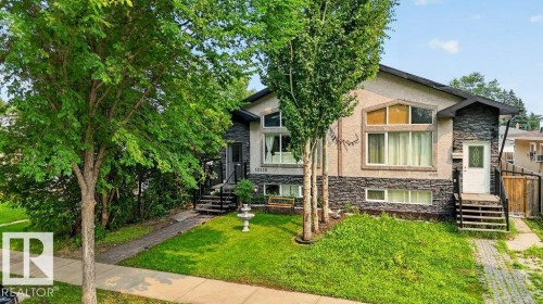 Stucco and stone facade property featuring multiple mature trees and a manicured lawn - 12219 89 Street Nw, Edmonton, AB - Outdoor