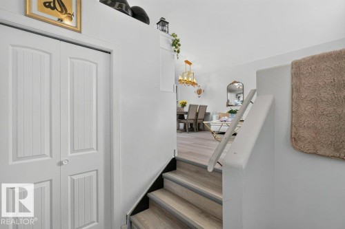 Split-level entry with light wood-finish flooring and white walls - 12219 89 Street Nw, Edmonton, AB - Indoor Photo Showing Other Room