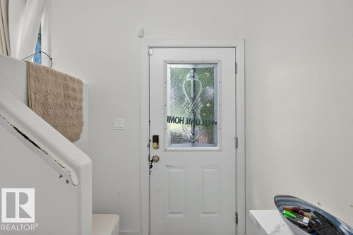 White paneled entry door with frosted glass insert - 12219 89 Street Nw, Edmonton, AB - Indoor Photo Showing Other Room