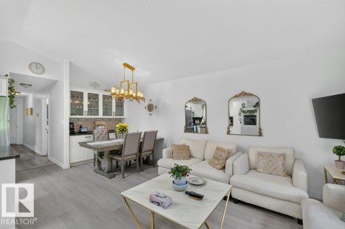Open-concept living area with light wood-finish flooring, white walls, and recessed lighting - 12219 89 Street Nw, Edmonton, AB - Indoor Photo Showing Living Room