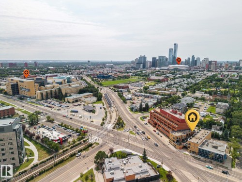 Aerial perspective showcasing a vibrant urban landscape with varied architecture - #201 10625 Kingsway Av Nw, Edmonton, AB - Outdoor With View