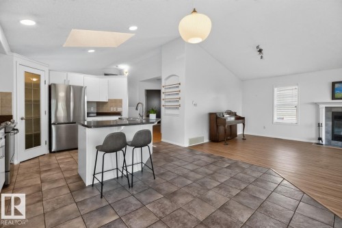 387 Foxboro Way, Sherwood Park, AB - Indoor Photo Showing Kitchen With Fireplace With Stainless Steel Kitchen