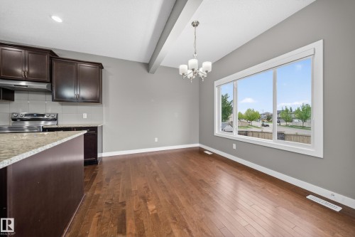 Open-concept living space with dark wood-finish flooring - 3639 15A Street Nw, Edmonton, AB - Indoor Photo Showing Kitchen