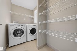 Dedicated laundry area featuring a front-loading washer and dryer - 