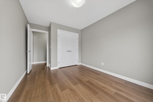 Interior room featuring wood-finish flooring, light gray wall paint, and white trim - 3639 15A Street Nw, Edmonton, AB - Indoor Photo Showing Other Room